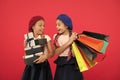 Shopaholic concept. Shopping become fun with best friends. Children satisfied by shopping red background. Obsessed with