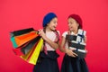 Shopaholic concept. Shopping become fun with best friends. Children satisfied by shopping red background. Obsessed with