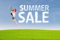 Shopaholic jumps with summer sale sign Royalty Free Stock Photo
