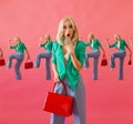 Shopaholic shocked blonde woman holding red bag on the pink background, shopping, sale, black friday concept Royalty Free Stock Photo