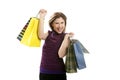 Shopaholic woman with colorful bags over white