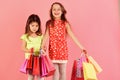 Shopaholics, childhood and fashion concept. Ladies buy clothes