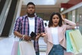 Shopaholics. Puzzled Black Couple Demonstrating Empty Wallet, Spent All Money For Shopping