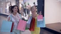 Shopaholism, beautiful female friends running through shopping center to in stores during black friday, text appears in