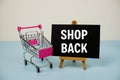 Shopback text message and trolley shopping cart on blue background Royalty Free Stock Photo