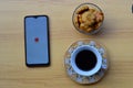 shopee apps on smartphone with coffe and cake foto concept