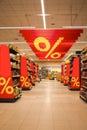 Shoping Concepts. View of Supermarket Aisles Between Products Displays With Discount Advertising During Sales Period
