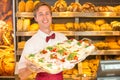 Shopkeeper in baker's shop with tray of sandwiches Royalty Free Stock Photo