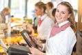 Shopkeeper at bakery working at cash register Royalty Free Stock Photo