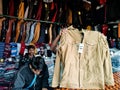 shopkeeper offering jacket during winter season at garment showroom in india dec 2019 Royalty Free Stock Photo