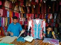 shopkeeper offering sweater during winter season at garment showroom in india dec 2019 Royalty Free Stock Photo