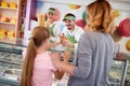 Shopkeeper in pastry shop gives ice cream to girl Royalty Free Stock Photo