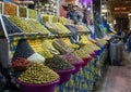 Shopkeeper selling world famous Moroccan olives in the Medina Souk in Meknes, Morocco.