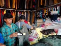 a shopkeeper showing man fashion outfits at garment store in india dec 2019