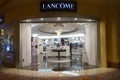 A shopkeeper walks in the LancÃ¯Â¿Â½me boutique in Macau