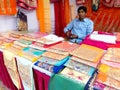 Shopkeepers on fabrics cloth stall in a Fair in India