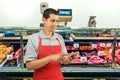 Butcher using smartphone Royalty Free Stock Photo
