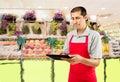 Shopman checking the delivery note at the greengrocery