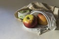 Shopper bag with collapsible silicone mug and apples in reusable fruit pouch