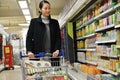 Shopper Browses a Supermarket Aisle