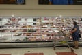 Shopper Buying Meat At Supermarket