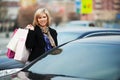 Fashion woman with shopping bags on car parking