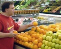 Shopper checks out fruit at the fruit section in a store