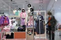 Shopper choosing dress in child clothes shop