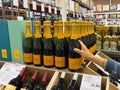 shopper graving a Bottle of Veuve Clicquot French champagne for sale