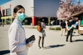 Shopper with mask standing in line to buy groceries due to coronavirus pandemic in grocery store.COVID-19 shopping safety