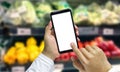 Shopper Mobile smart phone in hand, and see more detail and compare the prices in supermarkets