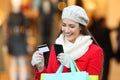 Shopper paying on line with phone and credit card
