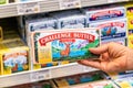 Shopper`s hand holding a box of Challenge Brand Salted Butter