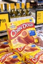 Shopper`s hand holding a box of Foster Farms Brand Corn Dogs