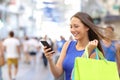 Shopper shopping with smartphone in the street