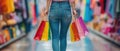 A Shopper Triumphantly Holds A Rainbow Of Purchases In Her Hand