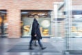 A shopper walking in front of shop window