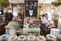 Shoppers Buying Fresh Fruit And Vegetables In Sustainable Plastic Free Grocery Store