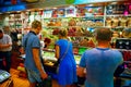 Shoppers choose sweets near the counter with banquettes, Turkish delight and nuts at the Grand Bazaar in Istanbul