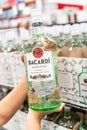 Shoppers hand holding a Bottle of Bacardi Carta Blanca Superior Brand White Rum