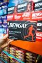 Shoppers hand holding a box of BENGAY brand topical analgesic cream tubes