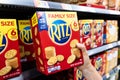 Shoppers hand holding a carton box of Ritz brand crackers