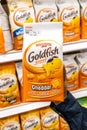 Shoppers hand holding a Package of Assorted Goldfish brand baked crackers