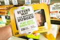 Shoppers hand holding a package of Beyong Meat brand plant based burger patties