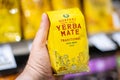 Shoppers hand holding a package of Guayaki brand Traditional Yerba Mate