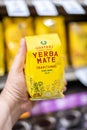 Shoppers hand holding a package of Guayaki brand Traditional Yerba Mate