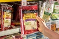 Shoppers hand holding a package of Sargento brand sliced natural pepper jack cheese
