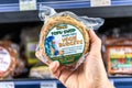 Shoppers hand holding a package of Tofu Shop brand organic vegie burgers