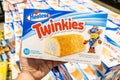 Shoppers hand holding a package of Twinkies brand golden sponge cakes