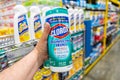 Shoppers hand holding a plastic container of Clorox brand desinfecting wipes